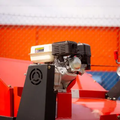 Elgra Engineering: A close up of the engine of an orange paddock Cleaner